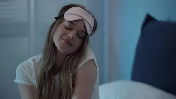 Young Woman Sleep Mask Closing Eyes While Sitting Bed Night — Stok fotoğraf