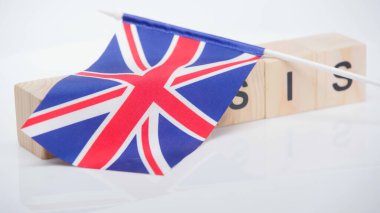 British flag on wooden cubes with crisis lettering on white background clipart