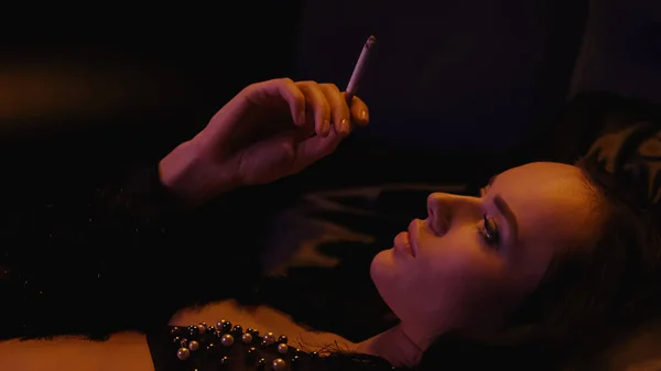 Brunette Woman Bra Holding Cigarette Lying Black Background — Stock Photo, Image
