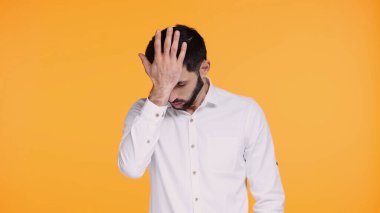 displeased bearded man in shirt touching head with hand isolated on yellow clipart