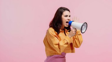 brunette woman screaming while making announcement in loudspeaker isolated on pink clipart