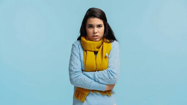 sad and diseased woman in scarf measuring temperature isolated on blue