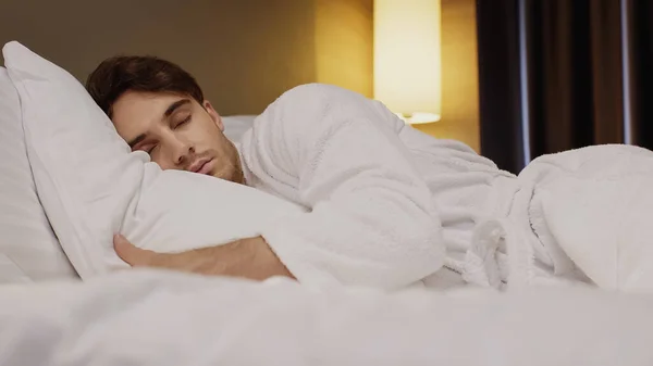 Surface level of man sleeping on bed in hotel room — Stock Photo