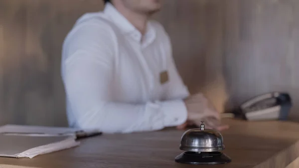 Cropped view of hotel receptionist at hotel counter — Stock Photo