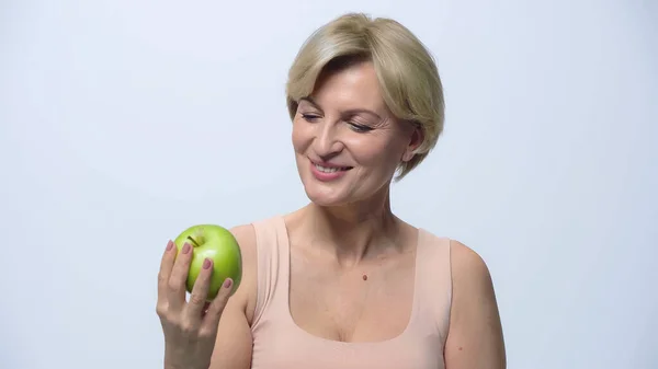 Souriant femme d'âge moyen tenant pomme fraîche isolé sur blanc — Photo de stock