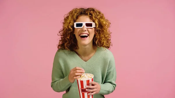 Excited woman in 3d glasses laughing while watching movie in cinema isolated on pink — Stockfoto