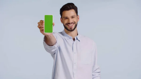 Happy man holding cellphone with green screen isolated on blue — Foto stock