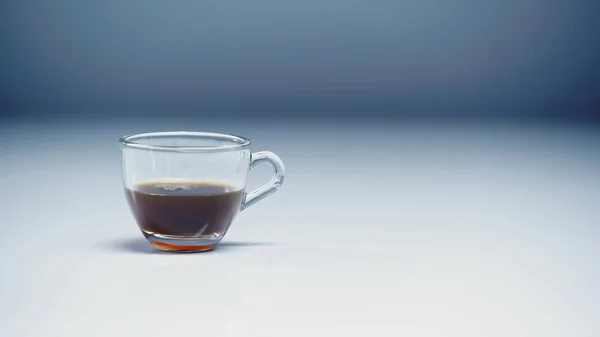 Prepared espresso in glass cup on white and grey — Stock Photo