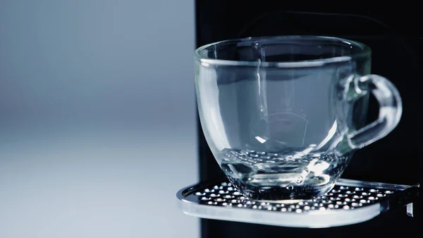 Close up of automatic coffee maker with glass cup on grey — Fotografia de Stock