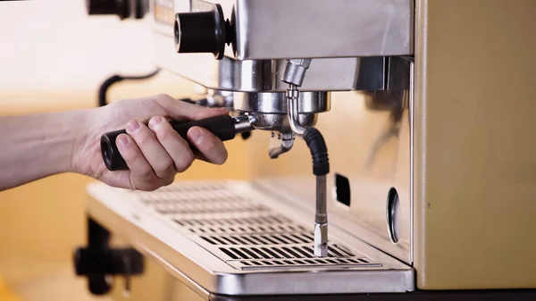 Cropped view of barista putting coffee filter holder — Stock Photo