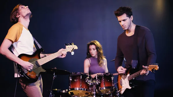 Young rock band performing together on stage — Photo de stock