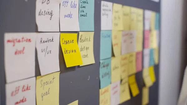Colorful sticky notes on grey board — Stock Photo