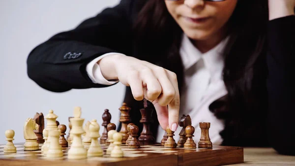 Cropped view of businesswoman playing chess isolated on white — Stock Photo