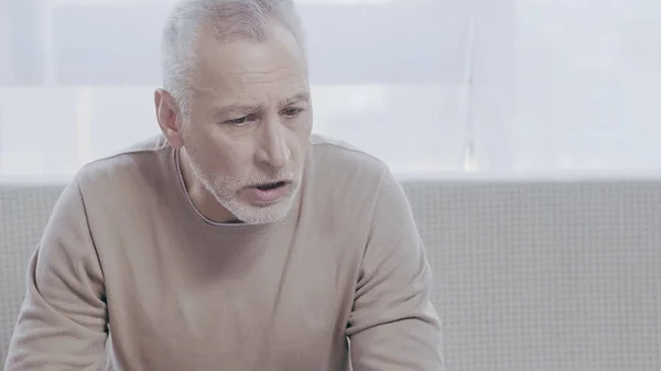 Sad mature man talking in consulting room during psychotherapy — Fotografia de Stock