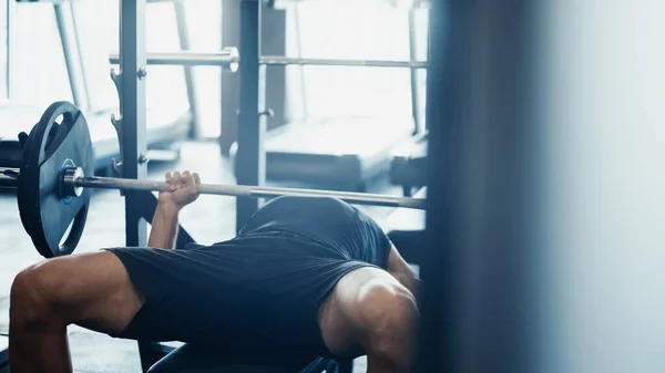 Strong sportsman weightlifting barbell in gym — Stock Photo