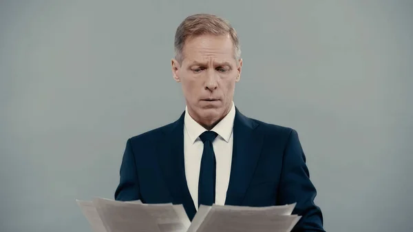 Businessman looking at papers isolated on grey — Foto stock