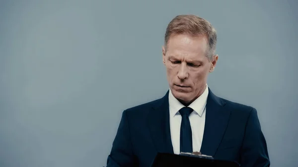 Businessman in formal wear holding clipboard isolated on grey — Fotografia de Stock