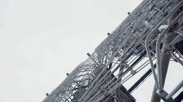 Bottom view of old radar station in chernobyl zone against grey sky — Stockfoto