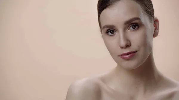 Young woman with clean skin and bare shoulders isolated on beige — Fotografia de Stock