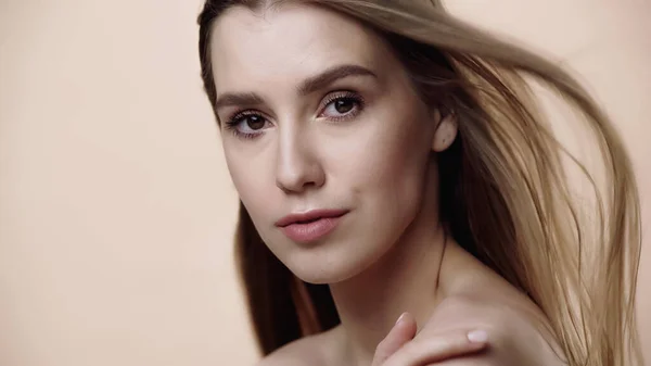 Pretty young woman with makeup isolated on beige — Stock Photo