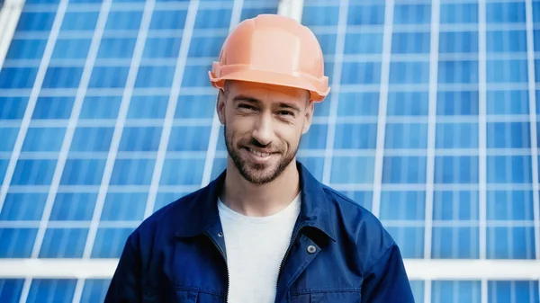 Happy engineer in orange helmet looking at camera — Stock Photo