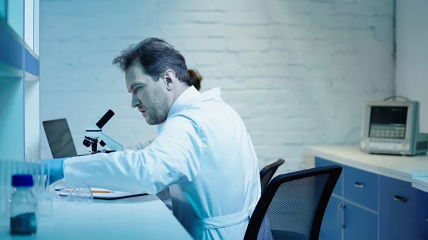 Two scientists making research near microscope in clinical laboratory — Stock Photo