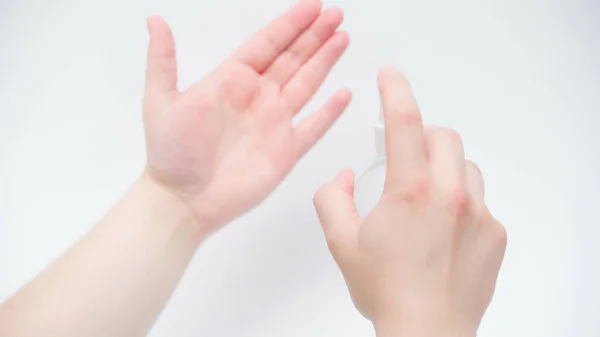 Cropped view of man applying hand sanitizer on white background — Stock Photo