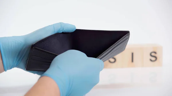 Cropped view of person in latex gloves holding empty wallet on white — Stock Photo