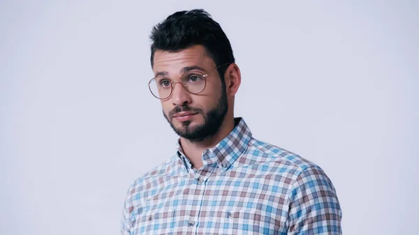 Pensive nerd in checkered shirt and eyeglasses looking away isolated on grey — Stock Photo