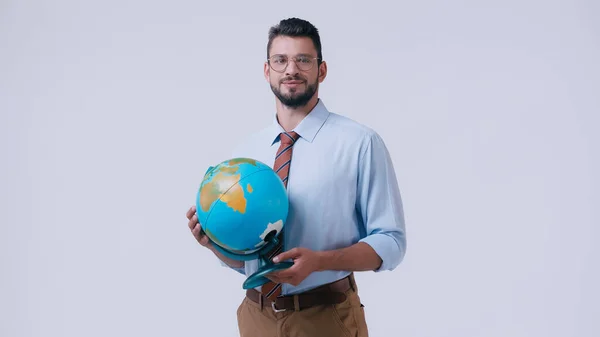 Smiling teacher in shirt and eyeglasses holding globe isolated on grey — Stock Photo