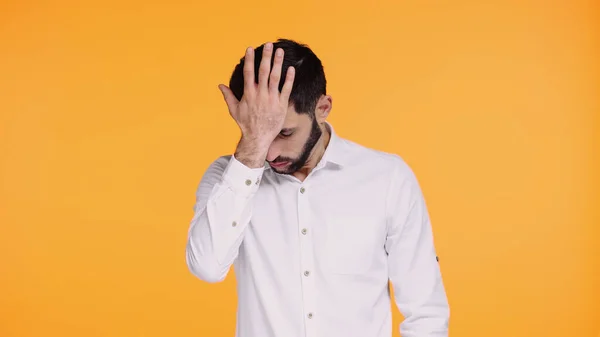 Displeased bearded man in shirt touching head with hand isolated on yellow — Stock Photo