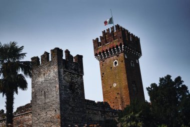 Lazise Castle, true fortress of the Western Verona at the shores of Lake Garda. Medieval castle towers viewed from below in dramatic light.