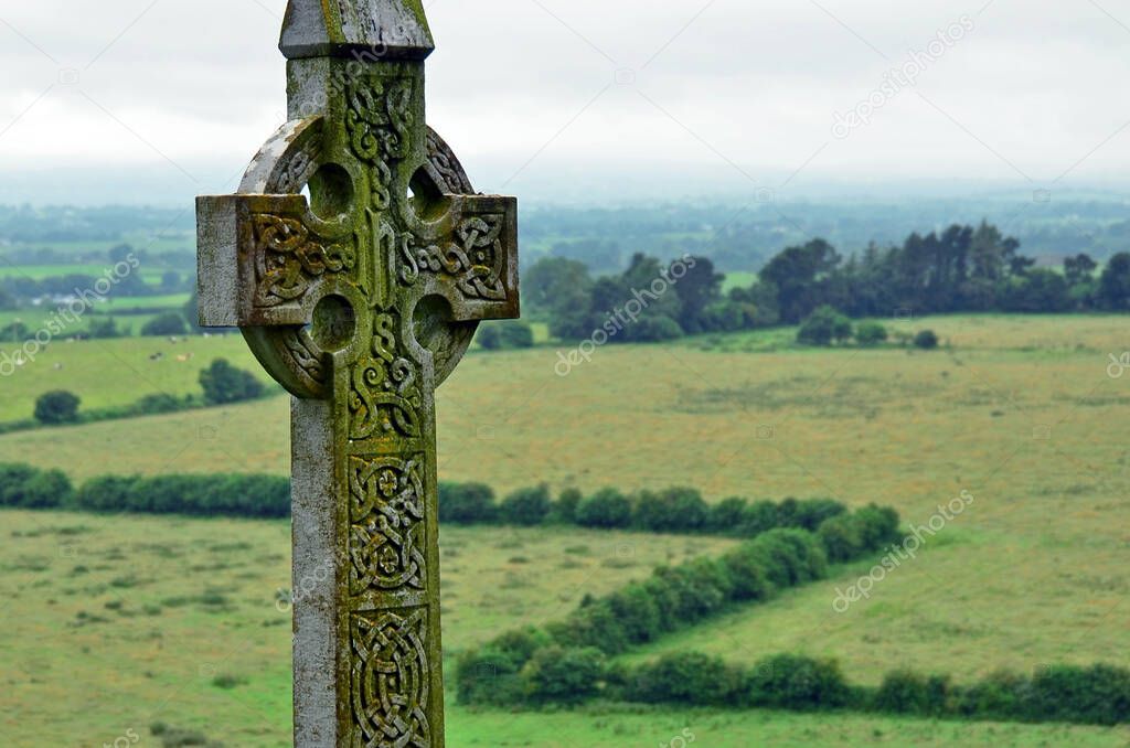 Celtic cross in Ireland.Big celtic gravestone with moss and lichen.
