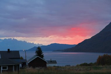 Emotional pink sunset above the Norwegian fjords. Nature beyond the arctic circle