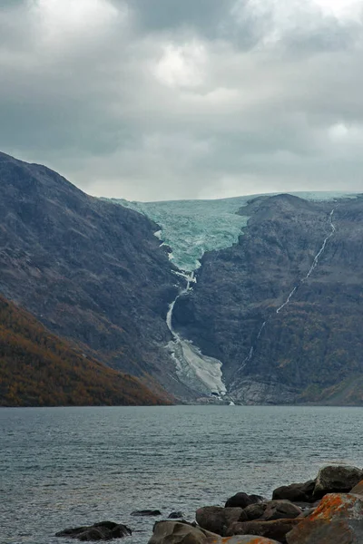 Huge glacier melts into the sea. Exciting view of a glacial phenomenon in northern Norway. Cold and ice.