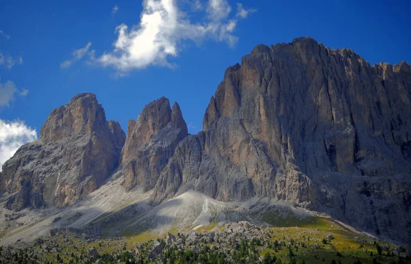 Large rocky mountains under a blue sky. Imposing mountains photographed from below. Panoramas of Trentino Alto Adige, Italy.