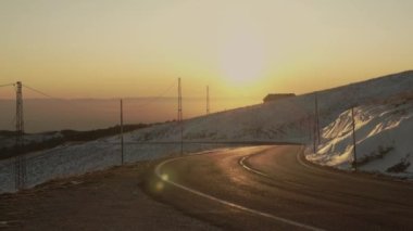 Sunset on mountain road trip. Peaceful sunset during a trip on the mountains.
