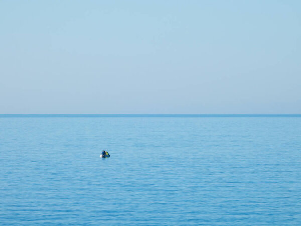 Three fishermen on an inflatable boat in the Mediterranean Sea