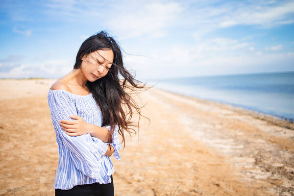beautiful one sensual asian girl on the beach and be sad concept