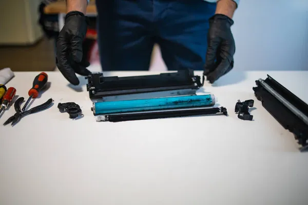 服务中心和车间的概念 人工充填打印机用的墨盒粉 白桌子上的墨水瓶 戴上手套的修理工 — 图库照片