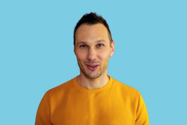 Portrait of charming young man feel content emotions wear yellow shirt isolated over blue color background