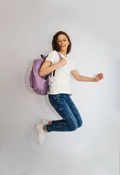 Excited Funny Kid School Girl Backpack Bag Jumping Flying Isolated — Zdjęcie stockowe