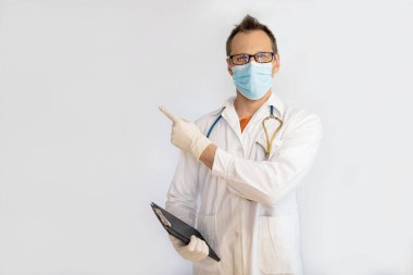 Middle aged man doctor, medical professional holding something in empty hand, isolated on white background