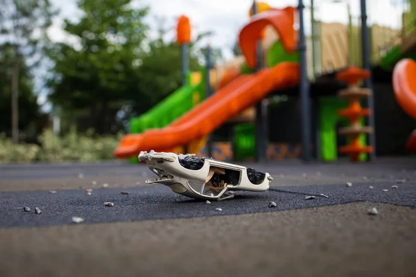 a broken children\'s toy is lying on the Playground, a broken toy car. War in Ukraine.