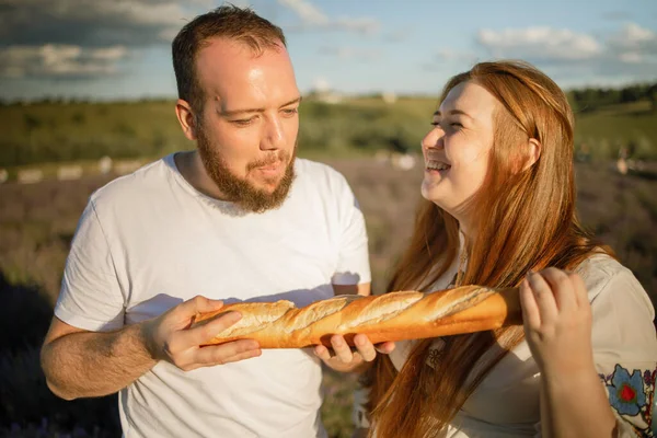 Hungry Couple Romantic Picnic Biting French Baguette Lavender Field Vacation — Φωτογραφία Αρχείου