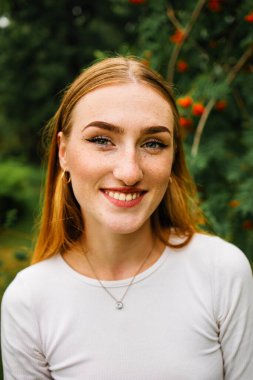 Close-up face of a young ginger ginger freckled woman with red hair and perfect healthy freckled skin isolated on white background.