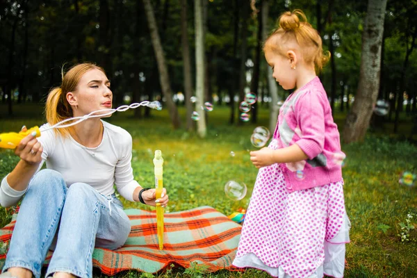 Young Mother Her Cute Little Girl Blowing Soap Bubbles Summer — Stok fotoğraf