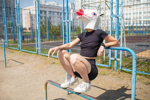 Woman Unicorn Head Sitting Horizontal Bars Outdoor — Photo