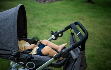 Little child sleeping calmly in push chair outdoor. Children day sleep and benefits for health concept