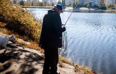 Elinde olta olan siluet balıkçıları, sonbahar gölünde hobi olarak balık avlamayı, gevşeme balıkçılık kavramını seviyorlar..